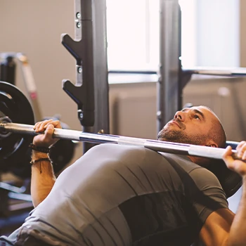 A person doing bench presses in the gym