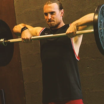 A man doing upright rows in the gym