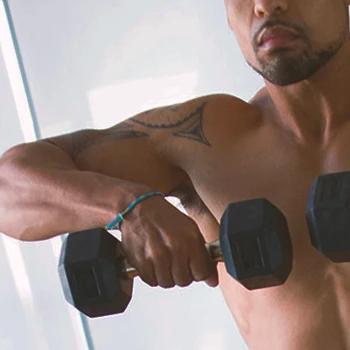 A person doing upright rows in the gym