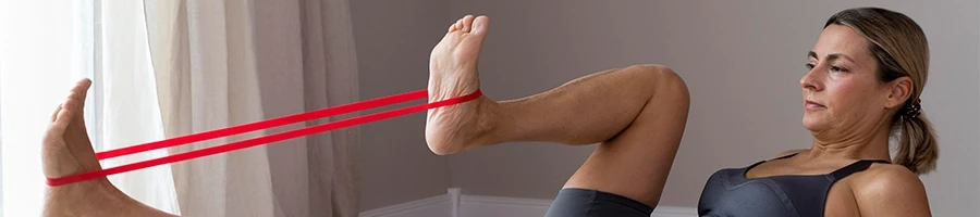 Using resistance band to stretch legs