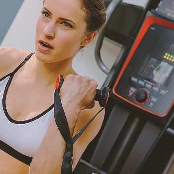 A woman using Bowflex for her workout routine