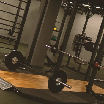 A wide shot of a power rack in a gym