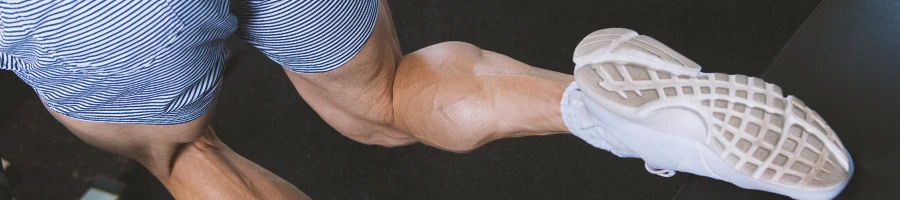 A person doing calf exercises in the gym