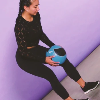 A person doing bent over medicine ball workouts