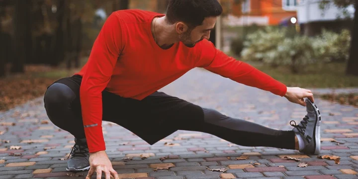 A person doing mobility exercises outside