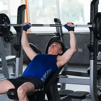 a photo of a man doing bench press