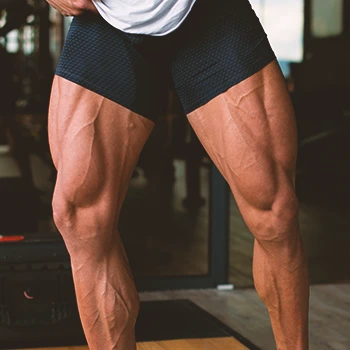 A muscular man flexing leg muscles
