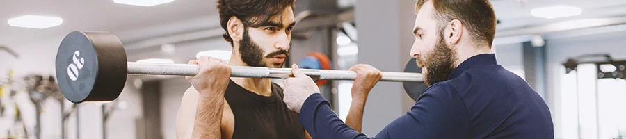 A gym coach helping a person plan a 7 day workout