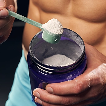 Holding a scoop of whey protein