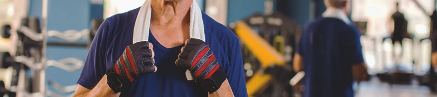 A man over 50 standing in the gym