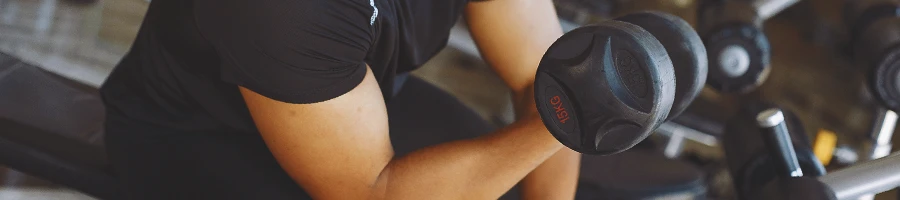 A person in the gym doing dumbbell curls