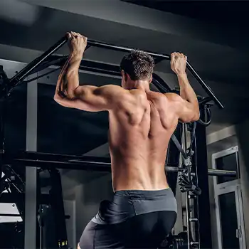 a photo of a man doing pull ups on the horizontal bar