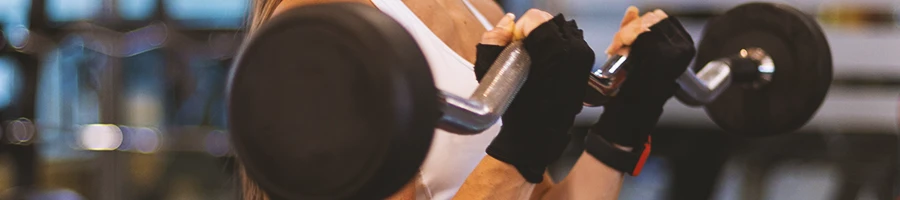 A person in the gym doing bicep curls