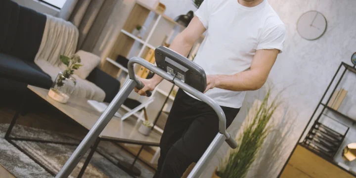 A person at a home gym using a treadmill