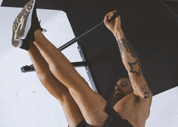 A person working out with a pull up bar on the wall