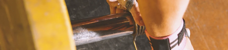 A person preparing a barbell for lifting