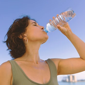 A person hydrating with water