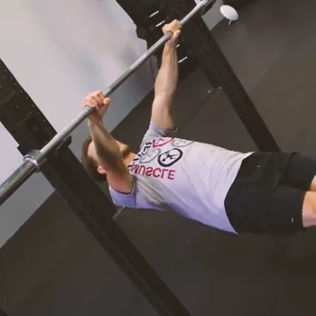 A person doing inverted rows at the gym