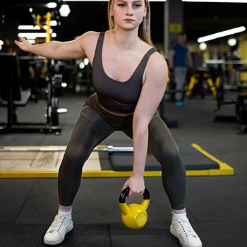 Doing a kettlebell snatch in the gym