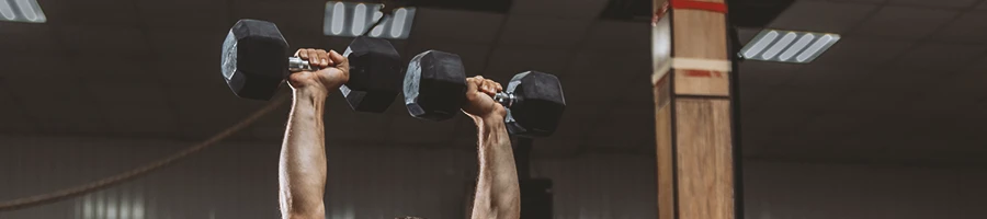 A person doing dumbbell overhead presses