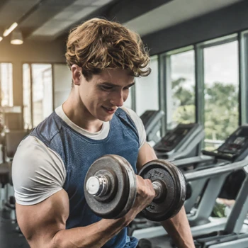 A young man doing dumbbell curls