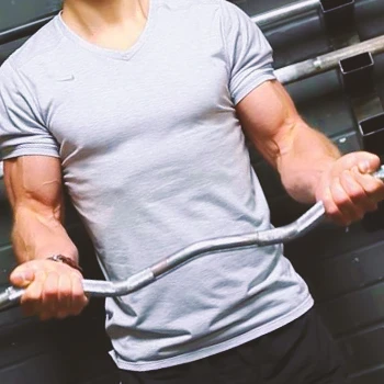 A person with a wide grip on a barbell