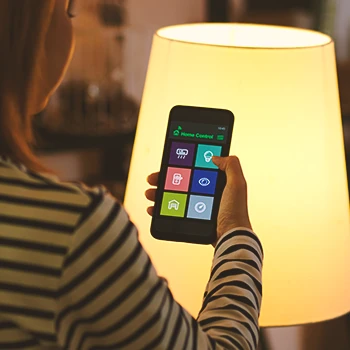 A person trying dimmable lights with an app