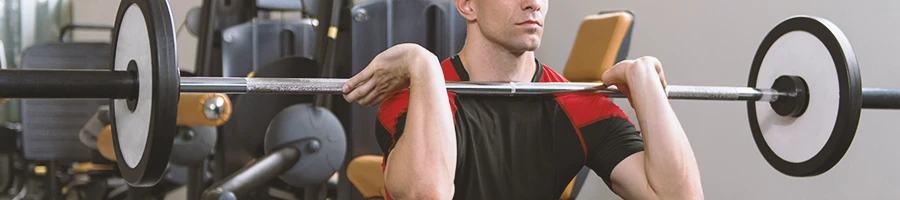 A person doing a good squat grip on a barbell