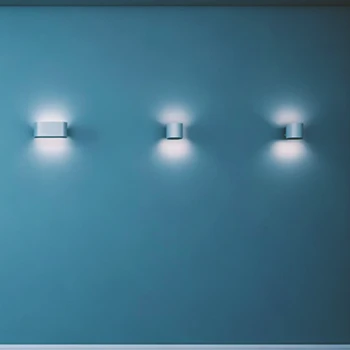 A shot of wall mounted lights on a blue wall