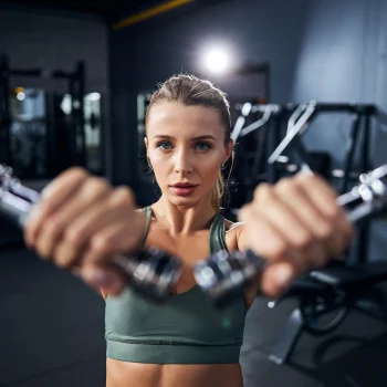Woman doing a dumbell front raise
