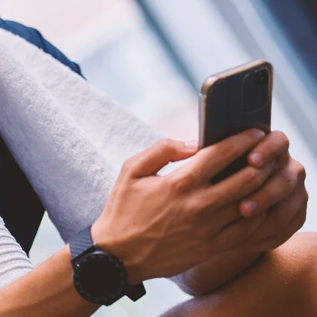 A person online shopping on a phone while in the gym