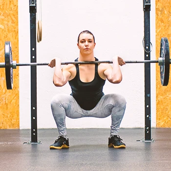 A person training front squats in the gym