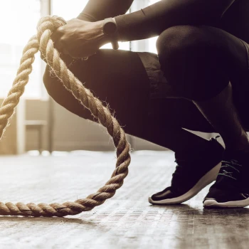 Man holding gym ropes
