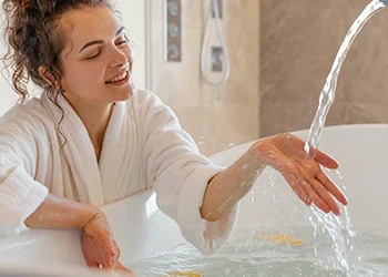 A person making an ice bath at home