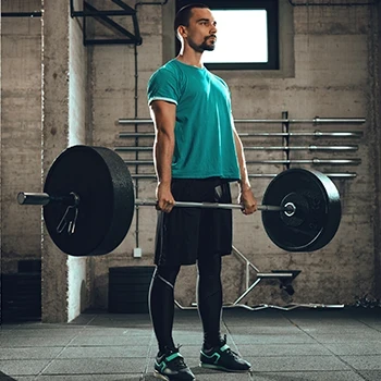 A man doing the proper technique in doing deadlifts