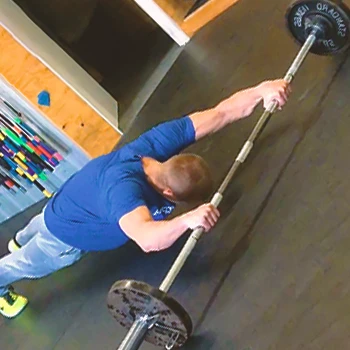 A person doing barbell roll outs