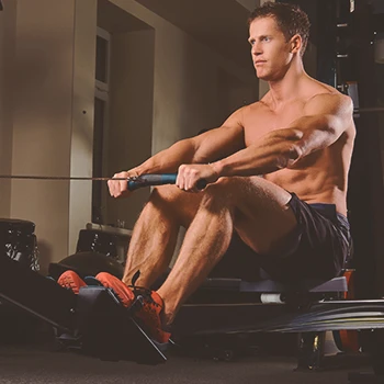 A man at the gym doing beginner HIIT rowing workouts