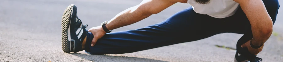 A person stretching his leg and hamstring muscles