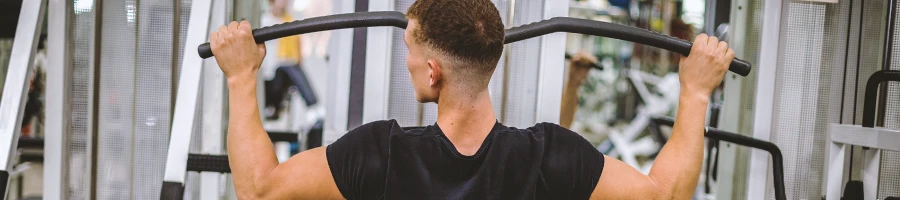 A person doing lat pulldown variations with proper form