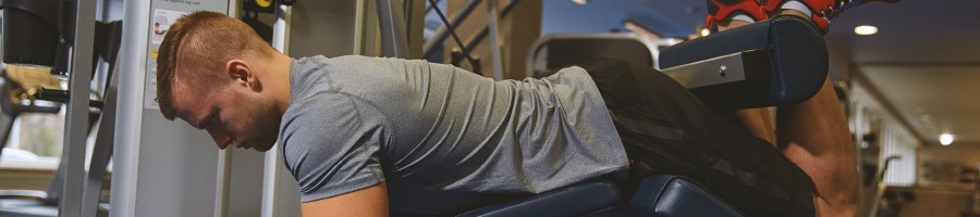 A person doing leg curl alternative workouts at the gym