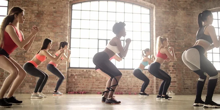 A group of women doing bodyweight leg workout