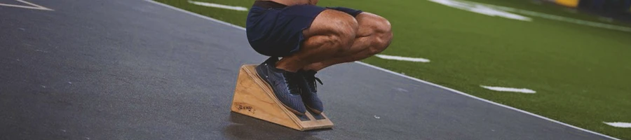 Close up shot of a person doing heel elevated squats