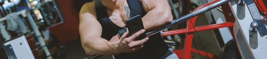 A person at the gym looking at a phone