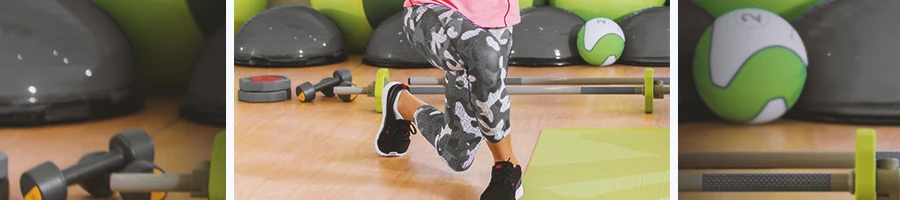 A person doing curtsy lunges at a home gym