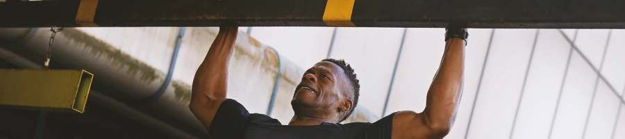 A person doing pull-ups at the gym