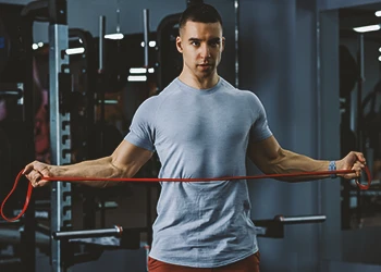 A person working out with a resistance band at the gym