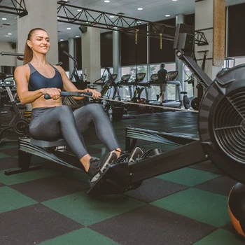 A woman at the gym doing rowing exercises for weight loss