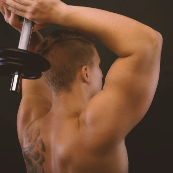 A person doing dumbbell triceps extension with proper elbow placement