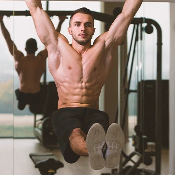 A person doing hanging leg raise workouts at home