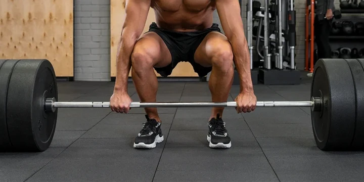 A man holding a barbell to do deadlifts